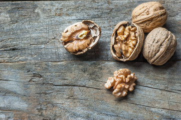 whole big peeled walnut kernel with thin shell on wooden background. healthy food for brain. Fresh walnuts  background nut concept