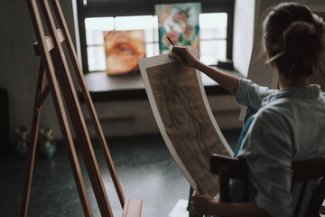 Rare view of the female artist with drawing in her hands