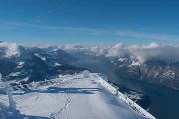 Swiss mountain peak after snowfall with panoramic view of Lake Lucerne (Vierwaldstattersee)