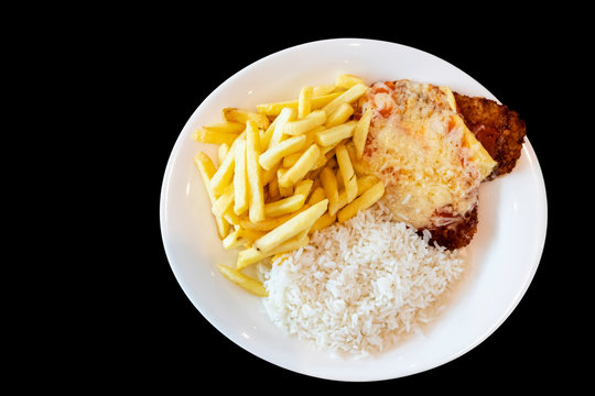 close-up on meal on plate, parmegiana chicken, potato chips and white rice, black background