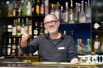 Professional bartender arm show OK in workplace closeup. High level and quality service. The concept of service.