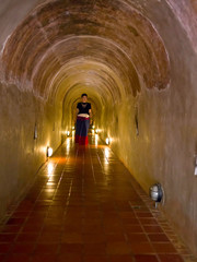 Femme en habit Thaï trditionnel dans le temple souterrain du Wat Umong