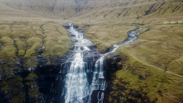 Aerial: Stream Flowing Through a Small Island Town