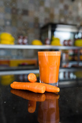 Glass of carrot juice and carrots