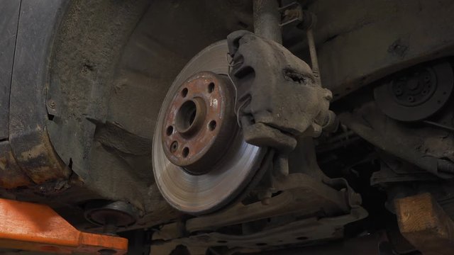 brake disk of the car on the lift in the service station
