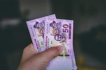 Bolivian money in the hand