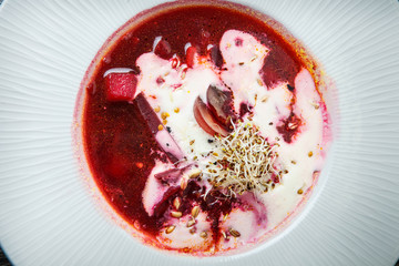 closeup ukrainian borscht decorated with sour cream and wheat sprouts