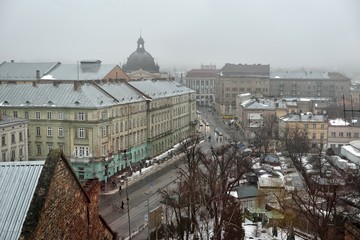 Rooftops of the old town in Lviv in Ukraine during the day. The magical atmosphere of the European city. Landmark, the city hall and the main square. Drone photo.