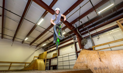 Man jumping and riding on a BMX bicycle at an extreme sports park