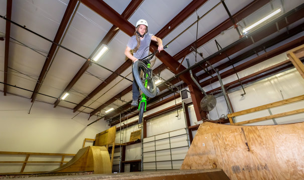Man jumping and riding on a BMX bicycle at an extreme sports park