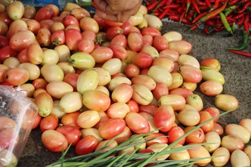 Naklejka na ściany i meble Fresh tomatoes for cooking in street food