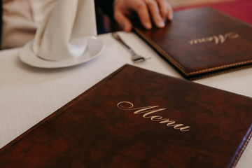 Man in restaurant reading the menu