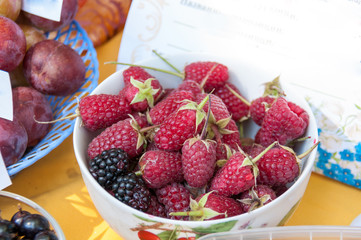 Berry raspberries in a cup on the table