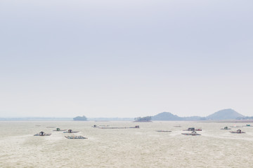 Landscape of the fishery farm in the natural lake during the cloudy day.