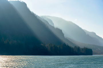 Mountain range illuminated by the slanting rays of the sun on the banks of the Columbia River in...