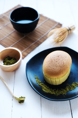 Mucha Japanese cheesecake and mucha green tea on White desk table in morning, Close up.