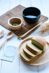 Matcha Japanese cheesecake and matcha green tea on White desk table in morning, Close up.