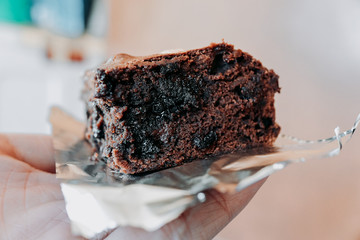 Close up hand holding chocolate brownies