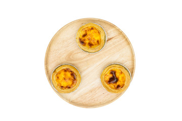 egg tart in aluminum foil cup on wooden dish, isolated on white background