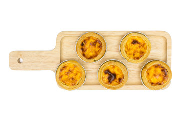 egg tart in aluminum foil cup on square wooden tray, isolated on white background, top view