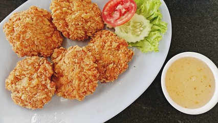 Tod Man Goong, Deep-fried breaded shrimp cakes served with sweet plum sauce, Thai style appetizers, close up top  view. 