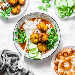 Pumpkin squash kofta with rice and curry sauce. Healthy vegetarian food on light background, top view