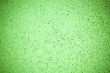 Rain droplets on green glass background, Water drops on green glass.