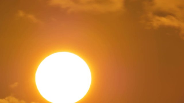 Sunrise timelapse in mountain. Big sun close-uo and clouds motion. Nature composition.