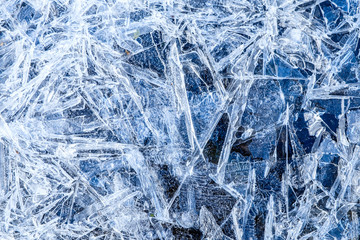 close up of dense ice crystal filled pond surface texture background on cold winter day