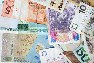 Different countries money background close up. Belarusian rubles, Georgian lari, Polish zloty, Israeli shekels, Vietnamese dongs