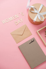 Obraz na płótnie Canvas Women's day concept, happy women's day, international women's day. Womans day text wooden, pink gift with picture frame on coral background