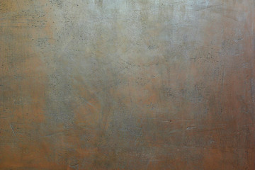 Grey brown painted scratched grunge plaster wall as abstract textured background.