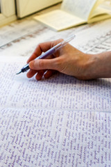 Woman hand with pen and paper with text on spanish language