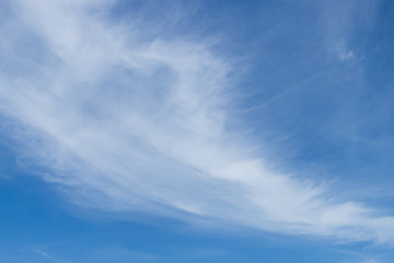 Thin white clouds on a blue sky.