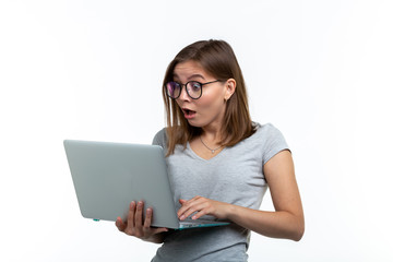 People and education concept - Surprised student woman holding a laptop over white background