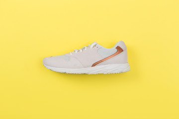 white Sneakers on yellow background. Interior poster.