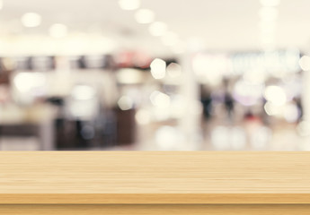 Empty wood table top on blur abstract background from inside shopping mall. Template mock up for display of product