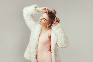 Beautiful fashionble woman in cozy fur coat