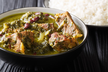 Authentic Ghormeh Sabzi dish of lamb stew meat with herbs and beans close-up in a bowl and rice. horizontal
