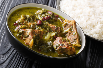 Delicious spicy Iranian dish Ghormeh Sabzi of lamb stew meat with herbs and beans closeup in a bowl. horizontal