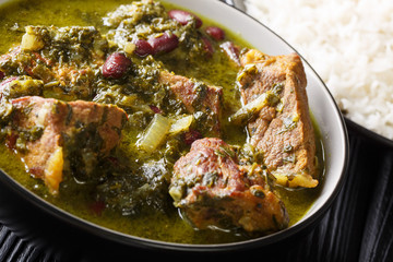 Ghormeh Sabzi lamb stew meat with different herbs and beans closeup in a bowl on the table. horizontal