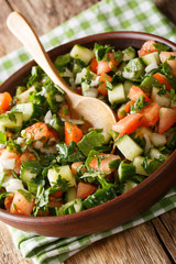 Persian Shirazi vegetable salad closeup on a plate on the table. vertical