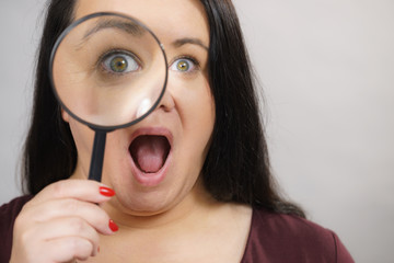 Adult woman with magnifying glss