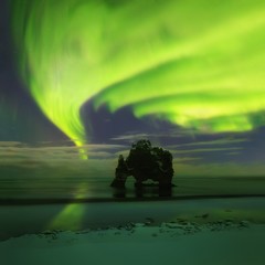 This beautiful northern lights or aurora borealis in Iceland was taken at or around Hvítserkur during a winter night. Green northern lights. Starry sky with polar lights. northern lights background 