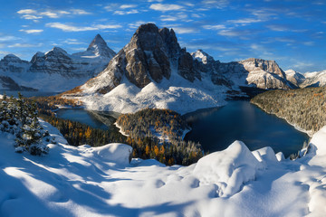 Winter sunny day. Mount Assiniboine, also known as Assiniboine Mountain, is a pyramidal peak mountain located on the Great Divide, on the British Columbia/Alberta border in Canada. 