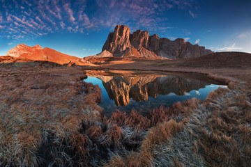 Scenic photo of Lake in the Dolomites of South Tyrol. The water of the lake reflects the peaks. Mondeval area is near Giau Pass at daylight. Clear sky. Italy