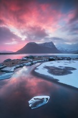 Sunset or sunrise panoramic view on stunning mountains in Lofoten islands, Norway, Mountain coast landscape, Arctic circle. Dramatic weather of a magic sunrise during this last winter. Amazing concept