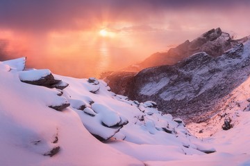 Sunset or sunrise panoramic view on stunning mountains in Lofoten islands, Norway, Mountain coast landscape, Arctic circle. Long exposure of a magic sunrise during this last winter