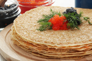 Russian pancakes with red and black caviar