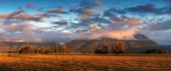 Sunset on meadows under the Fox Glacier / Te Moeka o Tuawe. It is temperate maritime glacier located in Westland Tai Poutini National Park on the West Coast of New Zealand's South Island.